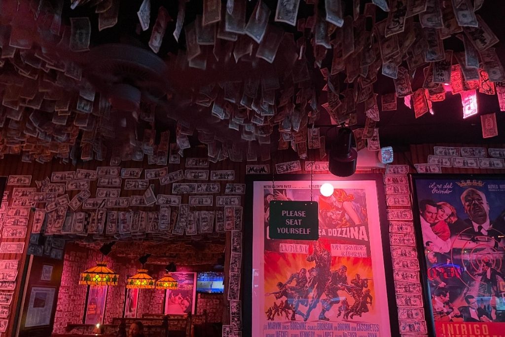 Checking out all the dollar bills on the walls and ceiling at Vinny McGuire's bar in Destin!