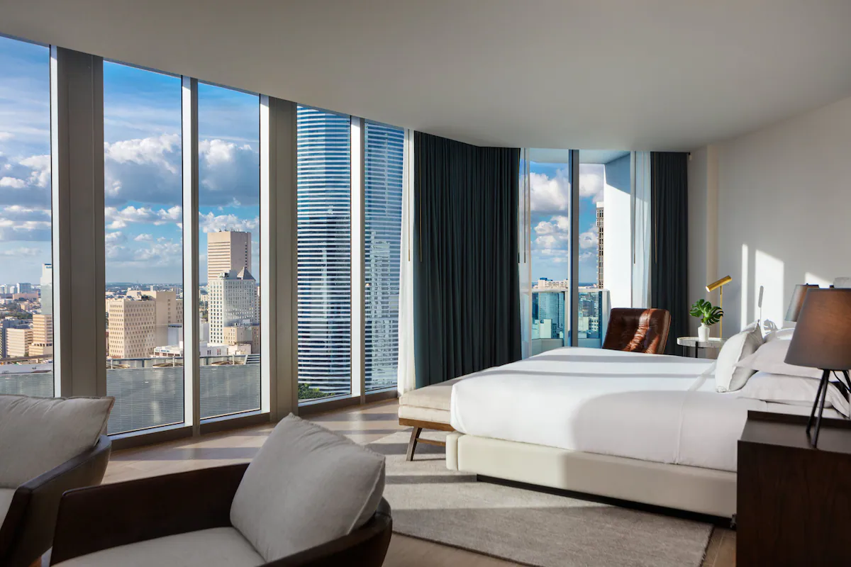 Interior bedroom with a view of the city at Miami EPIC Hotel.