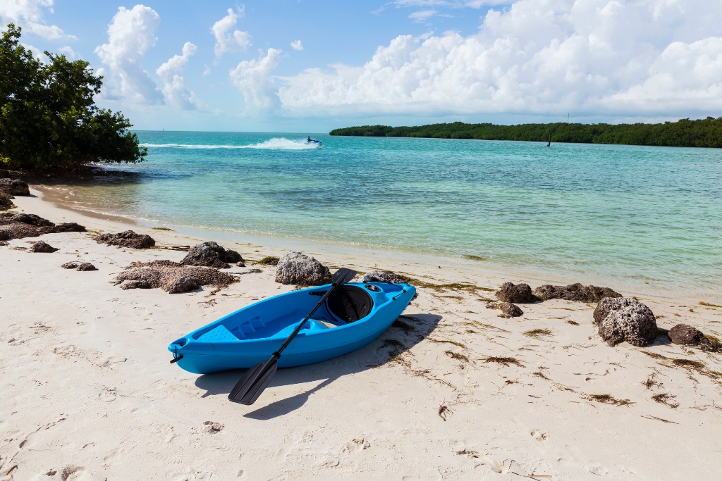 A blue kayak along the shore of Coco Plum Beach Florida