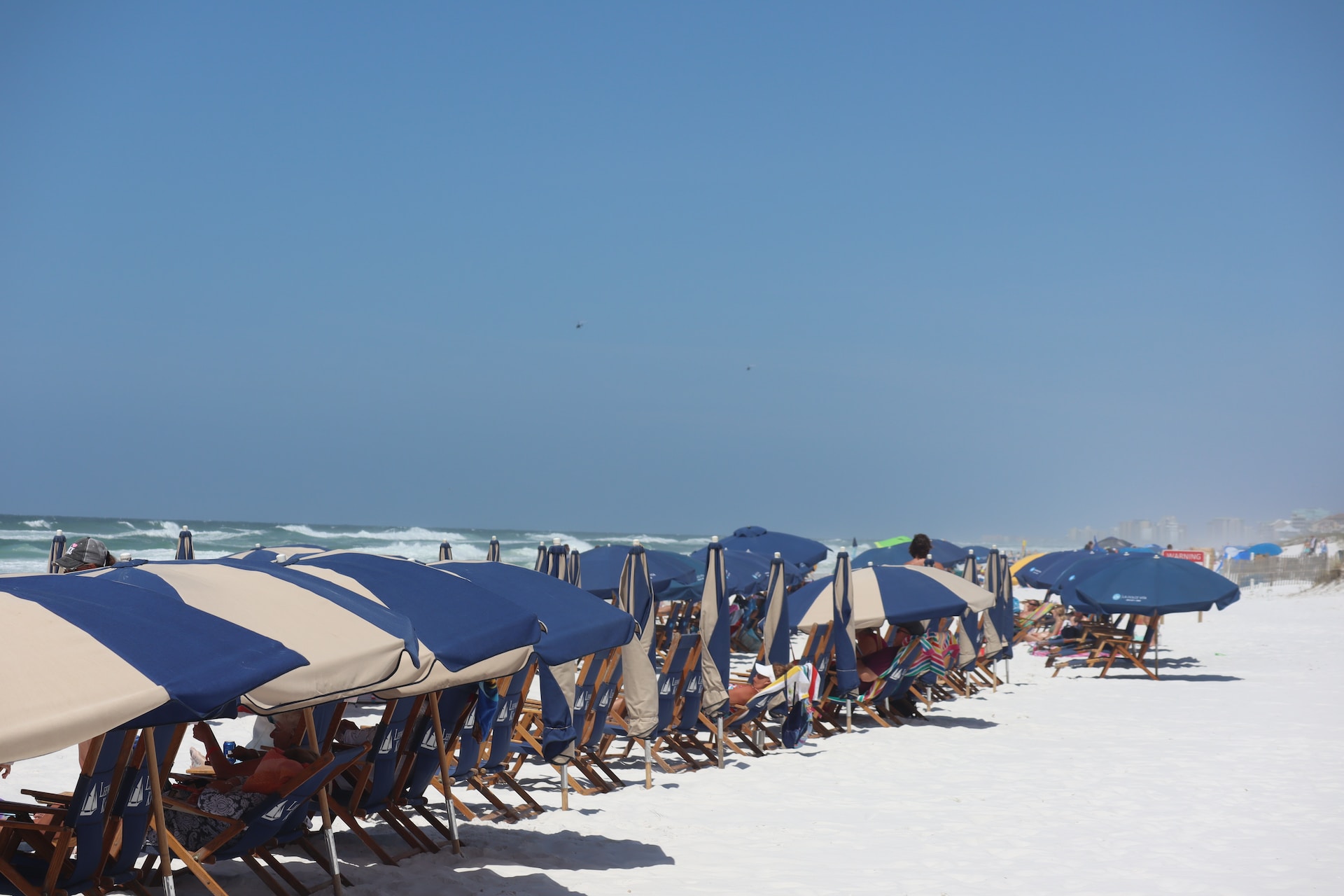 A row of beach umbrellas at Miramar Beach