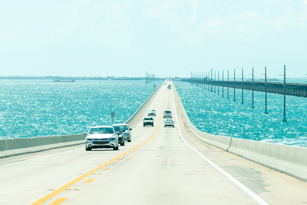 Road to Key West with cars running and a beautiful Caribbean blue waters