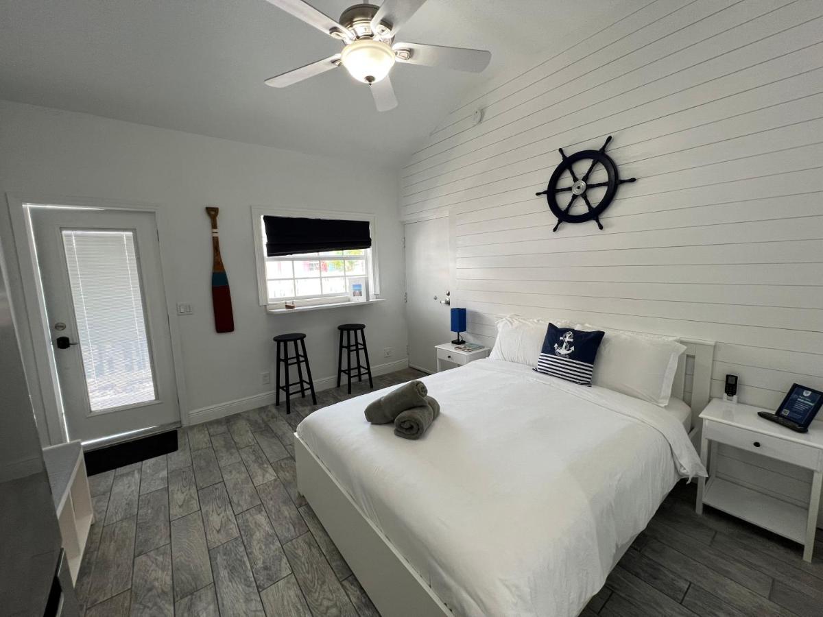 Blue Waters bedroom with queen size bed, white interiors and a navy touch