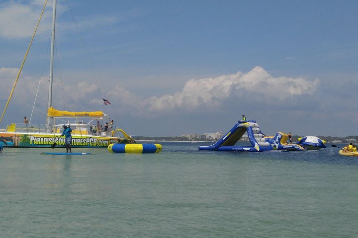 A Catamaran Sail with Inflatable slides and activities in the waters of Panama City Beach for an ultimate Water Adventure