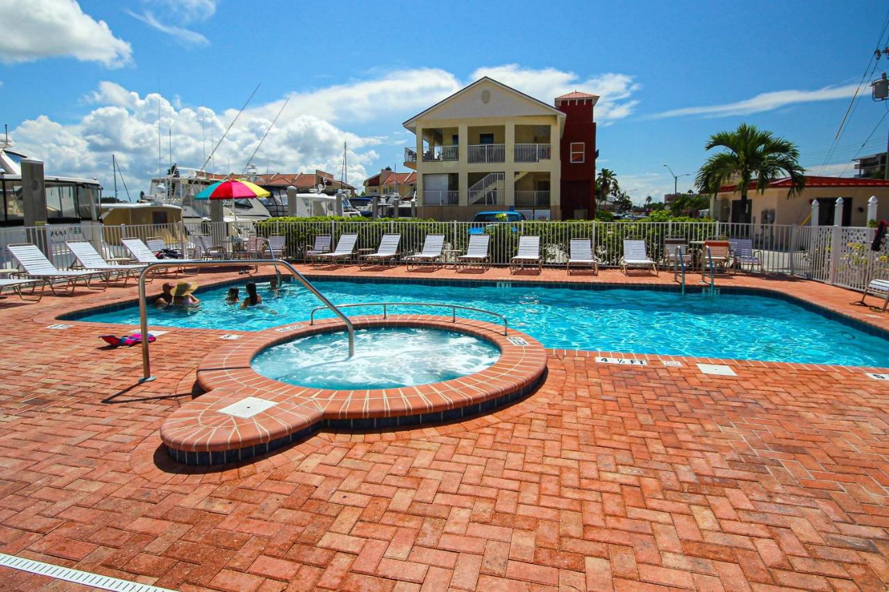 Exterior view of Madeira Bay Resort with an outdoor pool and guests swimming