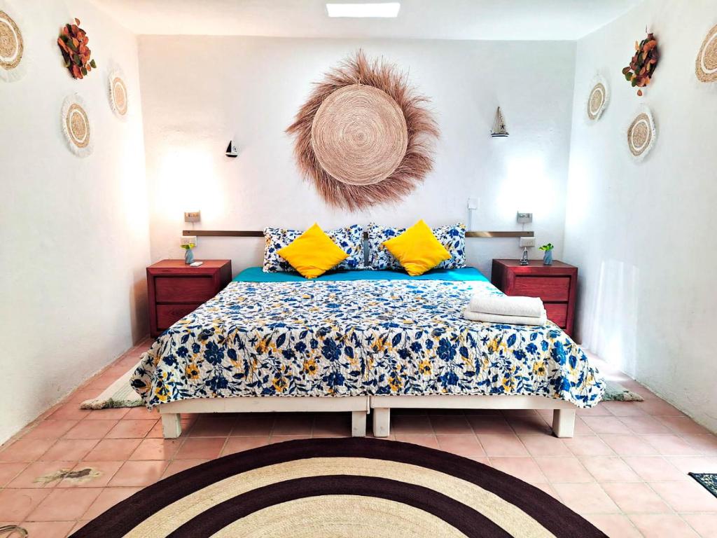 aesthetic bedroom with a king size bed and tropical design in Cozumel