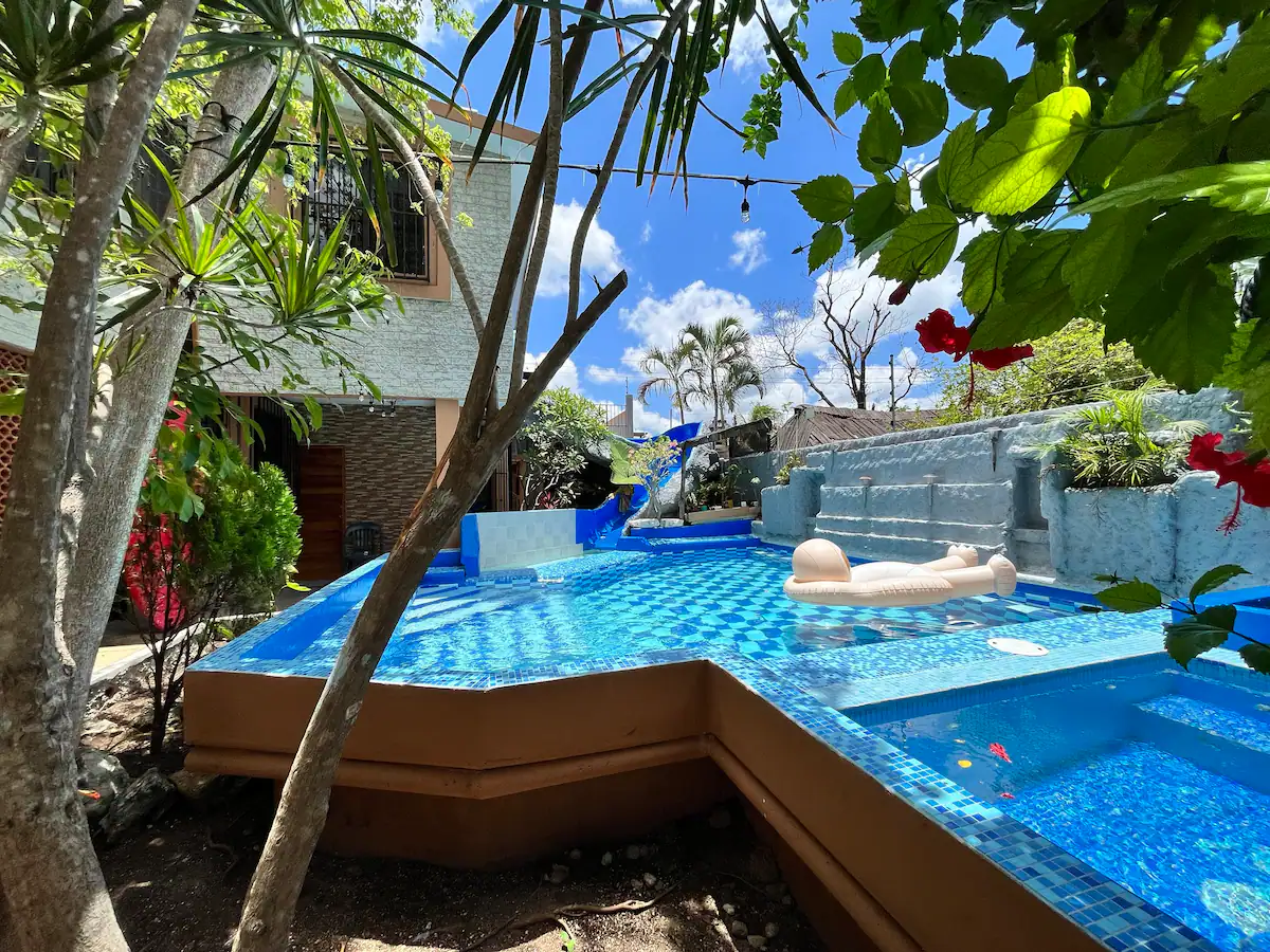an outdoor pool with water slide in a rental in Cozumel Bahamas