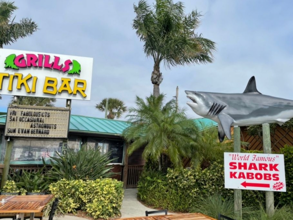 view of the Grill Tiki Bar from outside with amazing exterior and a big shark statue