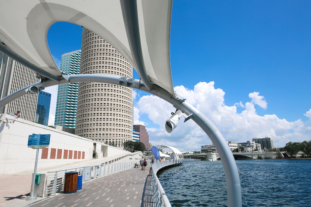 elevated walkway of Tampa Riverwalk with the view of the city skyline